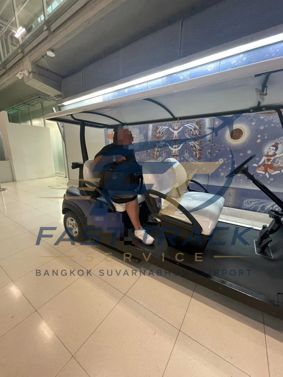Traveller seated in a FastTrack airport buggy